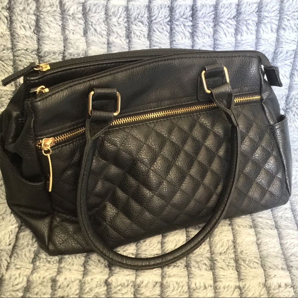 Handbag or shoulder bag black with gold detail.